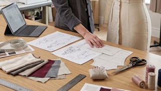 ODM product development — fashion design studio with designers and fabric swatches